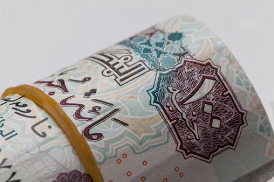 an egyptian money rolled up