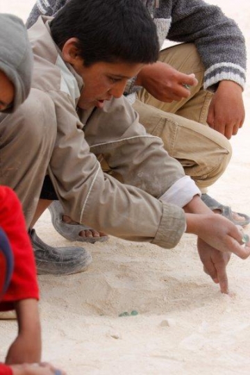 Boys playing glass balls  from Zaatari refugee camp for Syrian refugees
