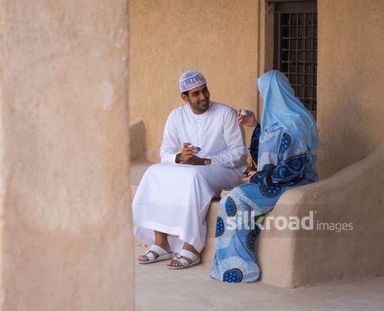 Couple drinking coffee outside|-