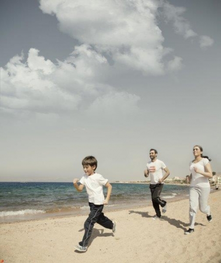 Family Running by the Sea