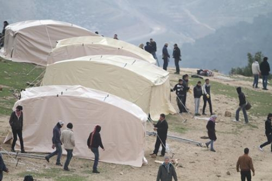 Palestinian demonstrators setting up tent at Bab al-Shams or Gate of the Sun 