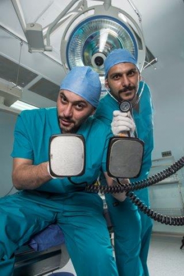 Surgeons Holding Electric Card
