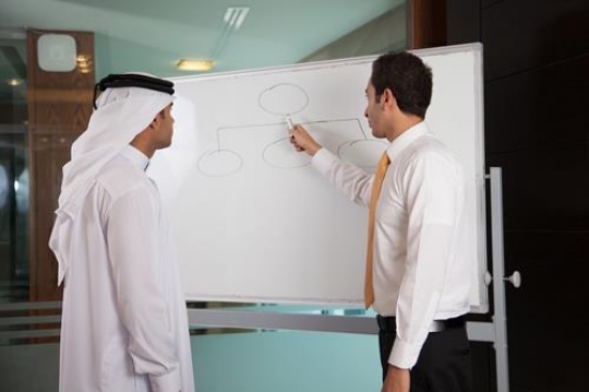 two young businessmen discussing a business strategy in a meeting