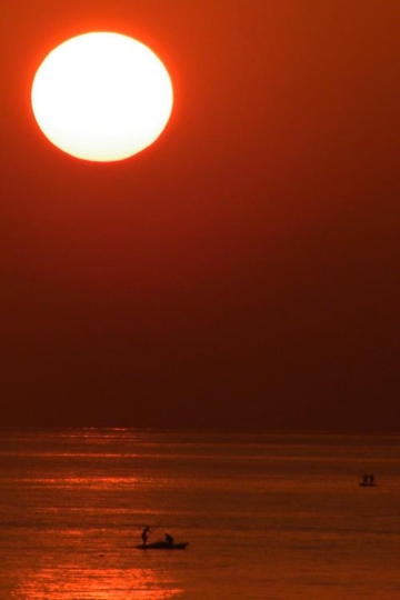 fishing boats at sunset
