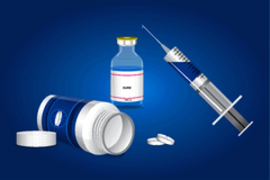 medical ampoules with pills and syringe on blue background