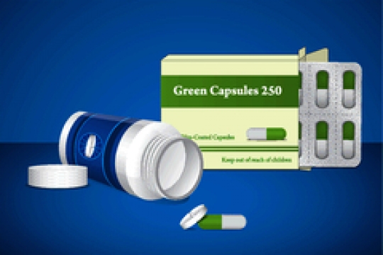 pill bottle and capsule pack on blue background