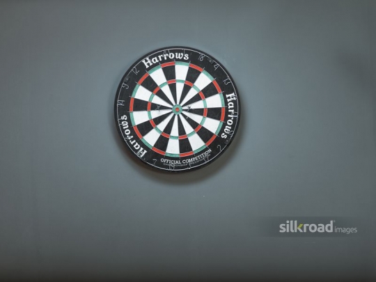 A dart board against the wall
