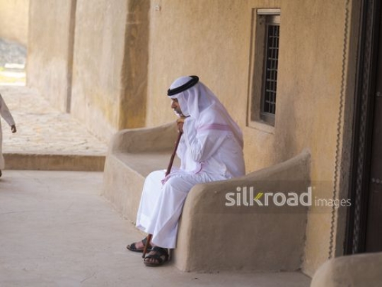 Old man leaning on stick|-