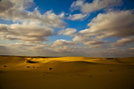 desert with clouds in the sky