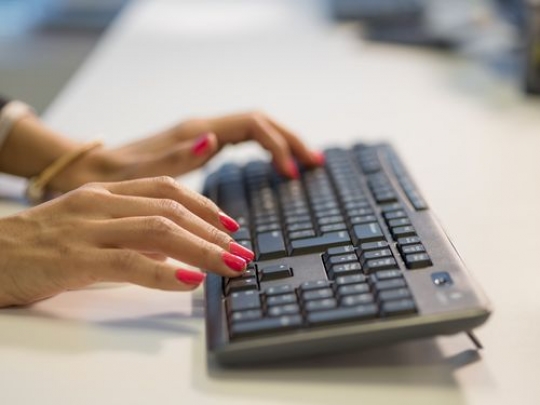 Woman typing on keyboard at the office|