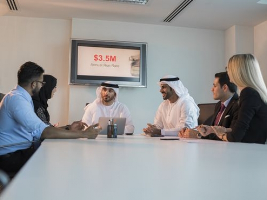 Business people during an update meeting|-