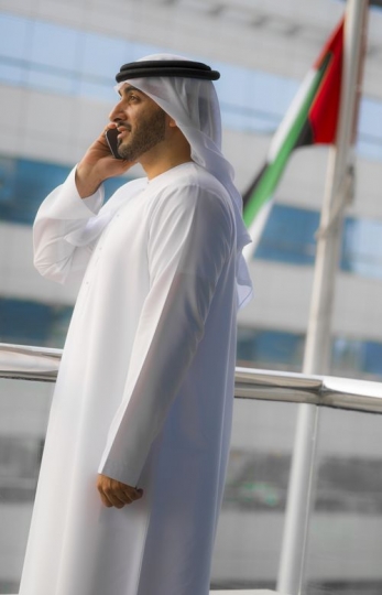 Arab man having a business conversation on the phone|-