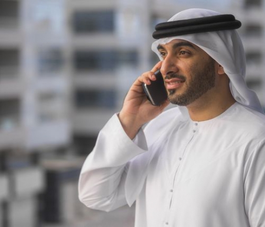 Business man standing outside talking on the phone|-