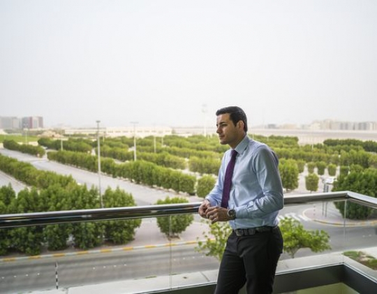 Business man standing outside at the balcony|-
