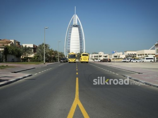 School Buses driving on a two lane road|-