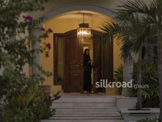 Arab woman leaving her home|