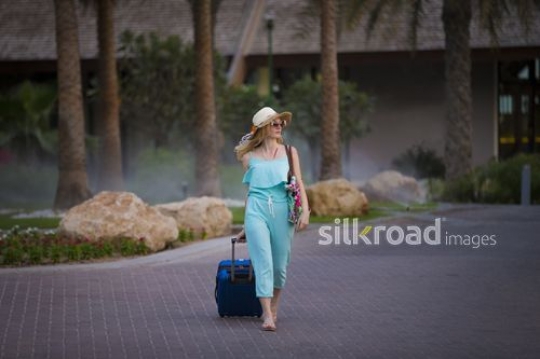 European woman walking around the resort|-
