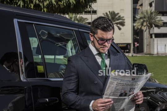 Western Businessman reading the newspapar|-
