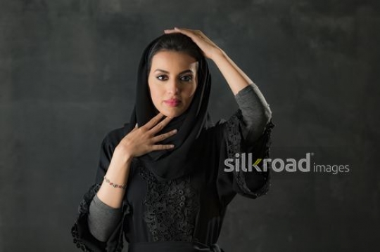 Middle Eastern woman fixing her shayla|