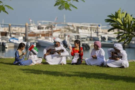 Arab man, teenagers and kids celebrating national day|-