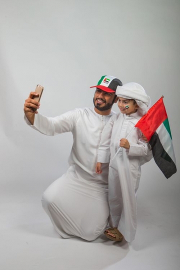 Emirati Father and Son celebrating National Day