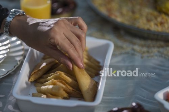 Woman taking food from the plate|-