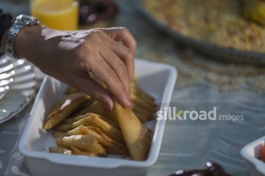 Woman taking food from the plate|-