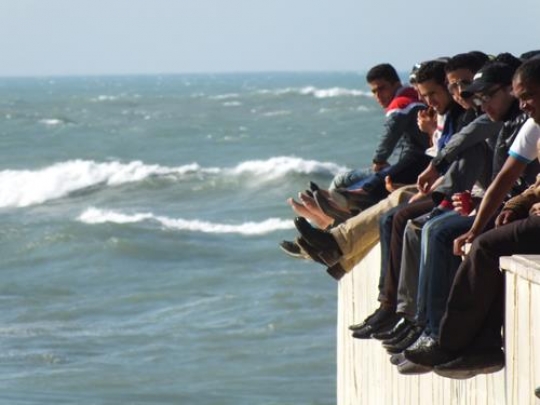 men sitting on casablanca beach