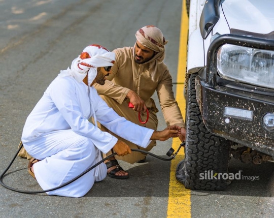 Men fixing car