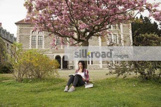 Student sitting on campus studying |