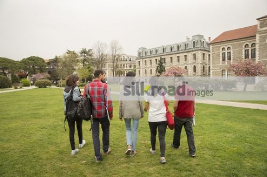 Friends walking on campus together|