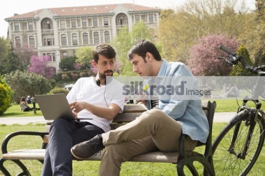 University Students sitting on the bench studying|