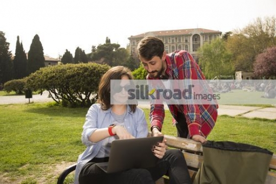 University students talking together using the device|