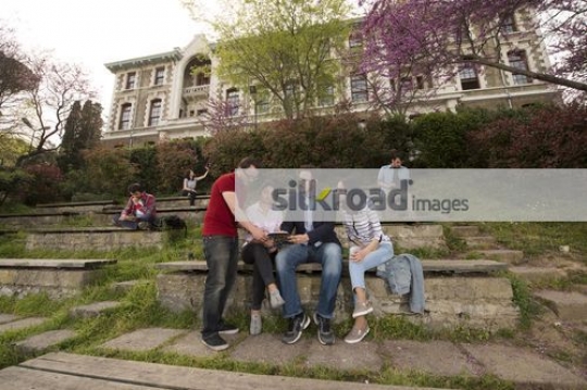 Students sitting talking to the professor|