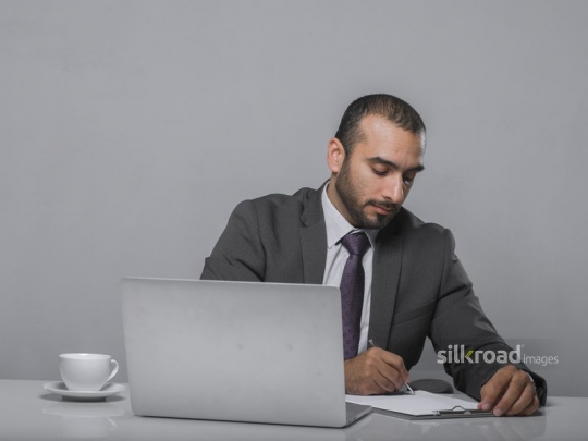 A Manager signing some documents