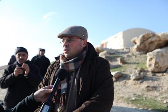 TV meeting with Palestinian demonstrator at Bab al-Shams or Gate of the Sun in Arabic, in a bid to draw attention to Israeli plans to boost settlement building in the West Bank area.