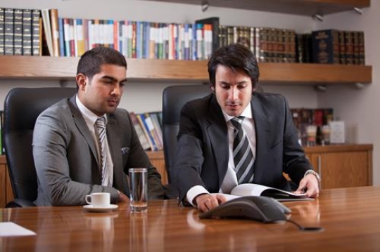 Young Male Executives Discussing Report