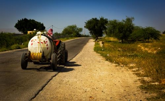 tractor on a road from amman to jordan valley