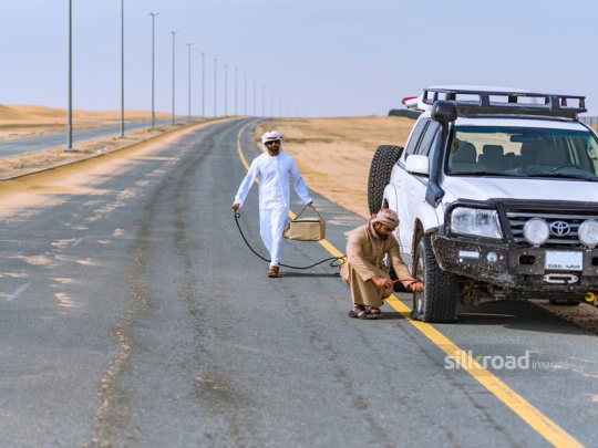 Friends fixing broken car