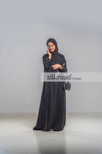 Middle Eastern woman talking on the phone|