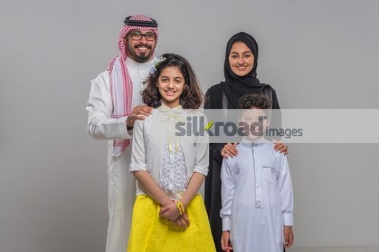Middle Eastern man and woman with the young kids|