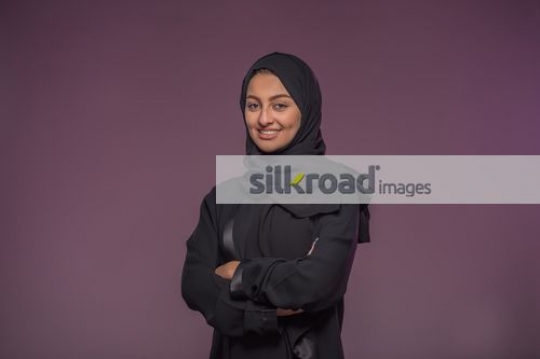 Middle Eastern Business woman standing arms crossed|