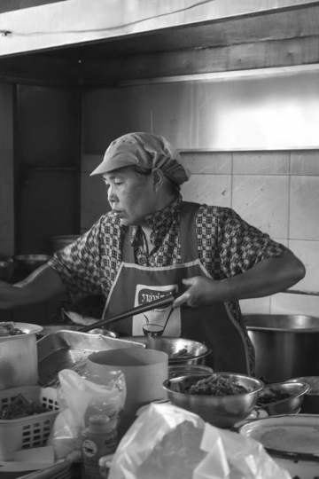 worker at a restaurant in black and white