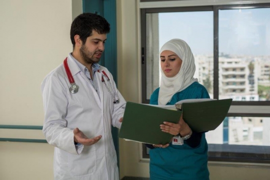 A Doctor and Nurse Discussing 
