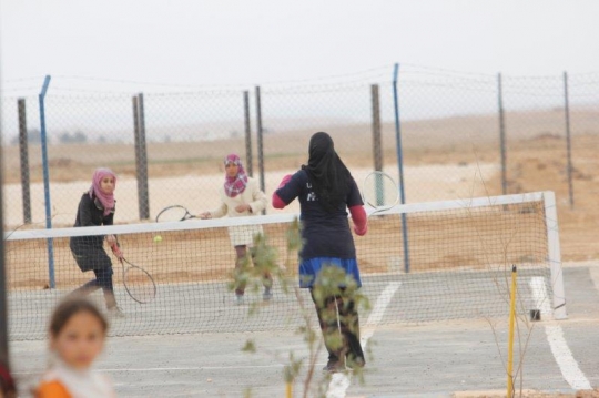 tennis ground behind a fence