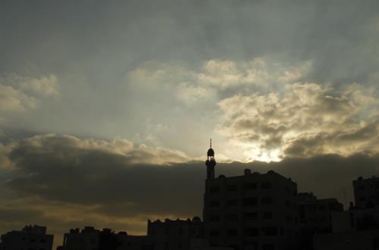 silhouette of mosque in sunset with clouds
