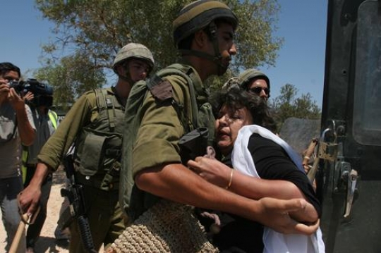 israeli soldier arresting woman
