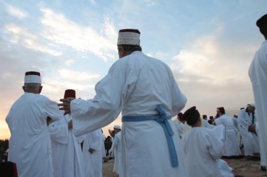 members of the Samaritan community march atop Mount Gerizim, above the West Bank city of Nablus,