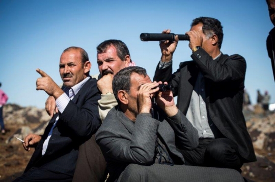 Syrian Refugees men Looking at Home Syria from Kobane Camp
