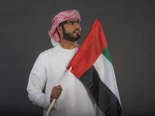 Proud Middle Eastern man celebrating the UAE National Day|